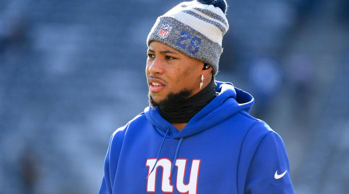 Saquon Barkley in a sweatshirt on the field before a game